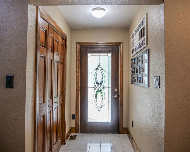 26 N Deer Lk, Villa Grove, IL 61956 - entryway with a textured wall, light tile patterned floors, and a textured ceiling
