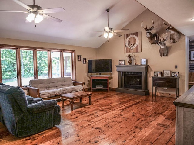 26 N Deer Lk, Villa Grove, IL 61956 - living room with ceiling fan, wood-type flooring, vaulted ceiling, and a fireplace with raised hearth