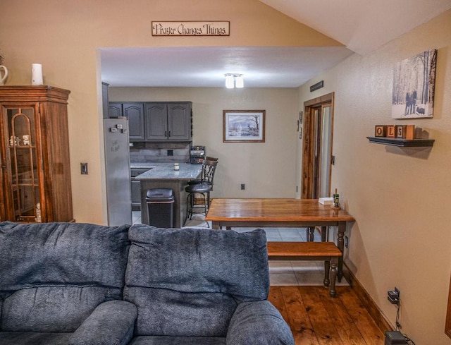 26 N Deer Lk, Villa Grove, IL 61956 - living room featuring hardwood / wood-style floors and vaulted ceiling