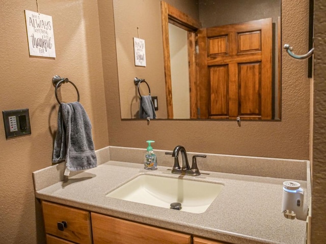 26 N Deer Lk, Villa Grove, IL 61956 - bathroom featuring vanity and a textured wall
