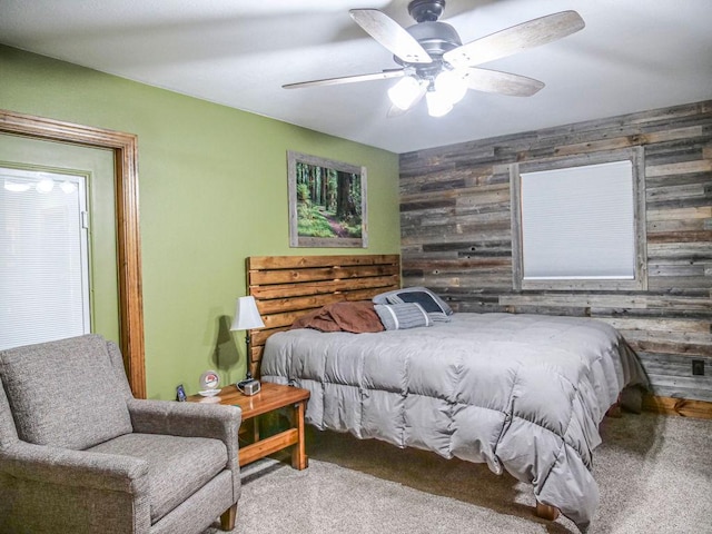 26 N Deer Lk, Villa Grove, IL 61956 - carpeted bedroom featuring wood walls, ceiling fan, and an accent wall