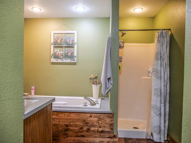 26 N Deer Lk, Villa Grove, IL 61956 - full bath featuring a stall shower, a bath, a textured wall, and vanity