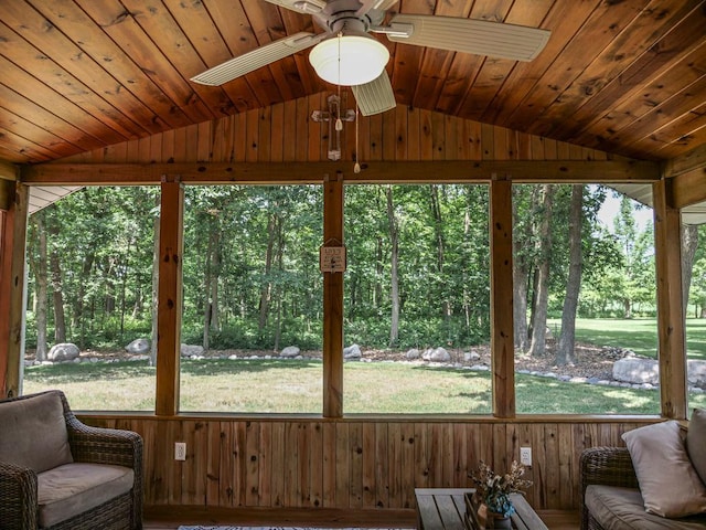 26 N Deer Lk, Villa Grove, IL 61956 - sunroom with vaulted ceiling, a ceiling fan, wooden walls, and plenty of natural light