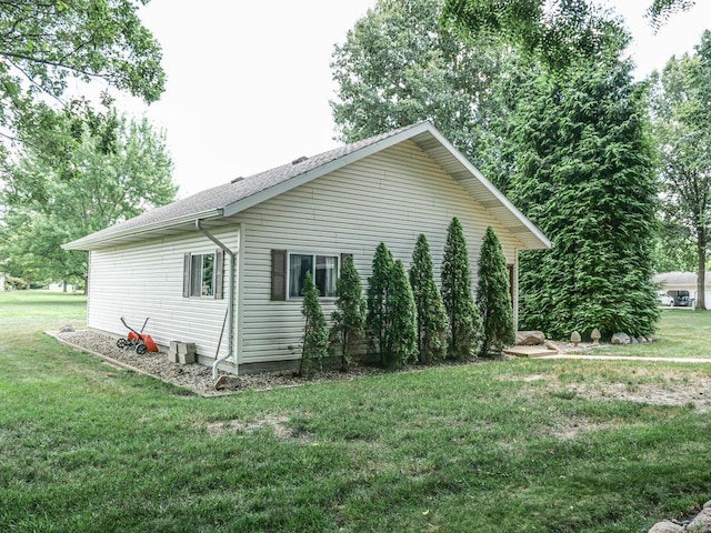 26 N Deer Lk, Villa Grove, IL 61956 - view of home's exterior featuring a lawn and roof with shingles