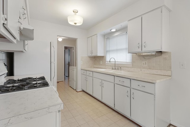 1108 Lancaster Ave, Elk Grove Village, IL 60007 - kitchen with light countertops, white cabinets, tasteful backsplash, washer / clothes dryer, and range