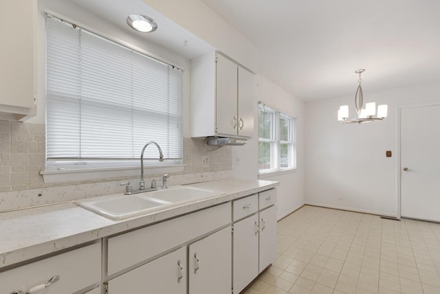1108 Lancaster Ave, Elk Grove Village, IL 60007 - kitchen with decorative backsplash, a chandelier, white cabinets, light countertops, and pendant lighting
