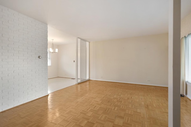 1108 Lancaster Ave, Elk Grove Village, IL 60007 - empty room featuring a chandelier and brick wall