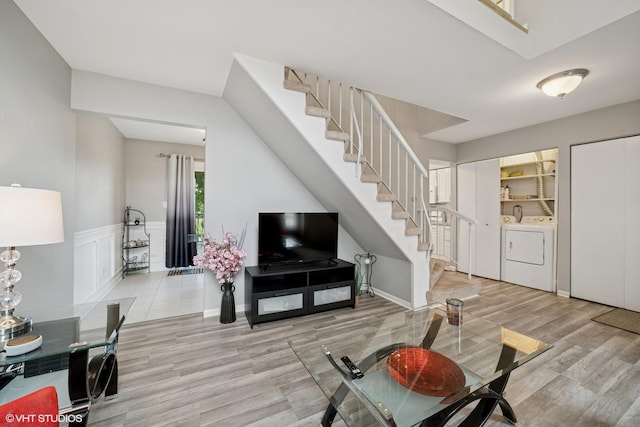1117 Sausalito Ct Unit 1117, Bartlett, IL 60103 - living area featuring washer and clothes dryer, stairway, wood finished floors, and wainscoting