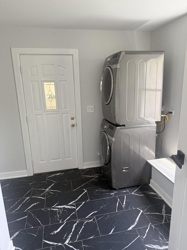 309 SE Circle Dr, Joliet, IL 60433 - laundry area featuring stacked washing machine and dryer and dark marble finish floors