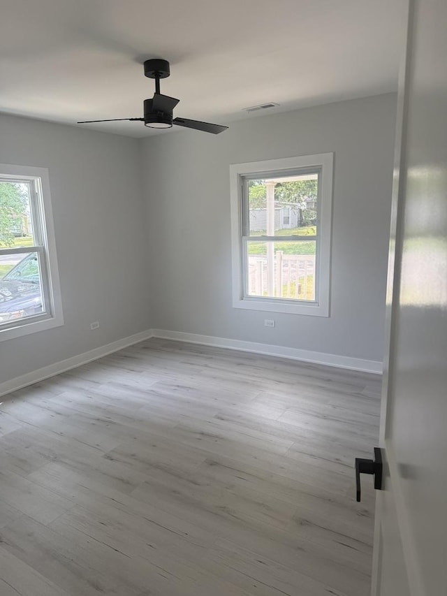 309 SE Circle Dr, Joliet, IL 60433 - empty room featuring healthy amount of natural light, wood finished floors, and ceiling fan