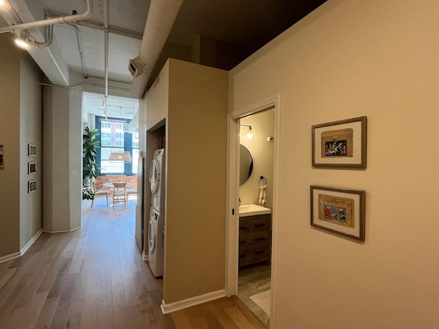 124 W Polk St Unit 203, Chicago, IL 60605 - corridor with stacked washing machine and dryer and wood finished floors