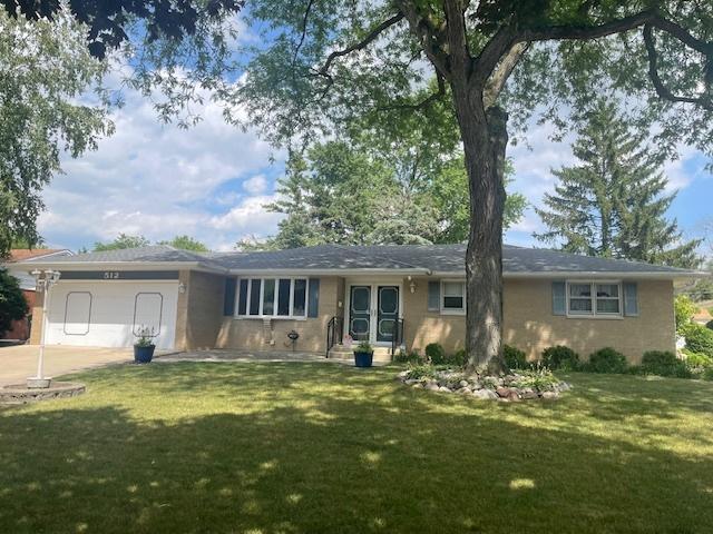 512 Tana Ln, Joliet, IL 60435 - ranch-style house with a front lawn, an attached garage, and concrete driveway