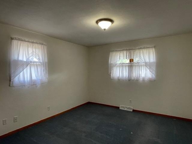 512 Tana Ln, Joliet, IL 60435 - spare room featuring healthy amount of natural light and dark carpet