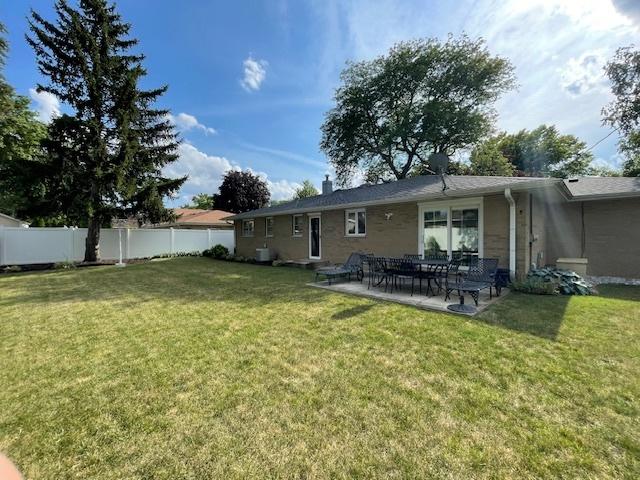 512 Tana Ln, Joliet, IL 60435 - back of property featuring a patio and a chimney