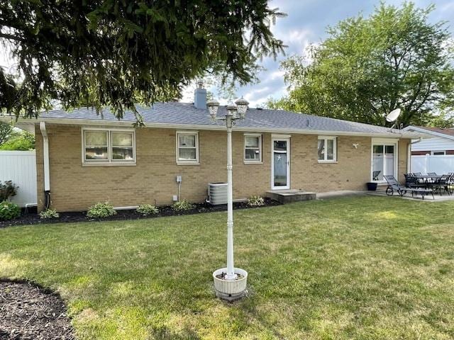 512 Tana Ln, Joliet, IL 60435 - rear view of house with a chimney, brick siding, and a patio area