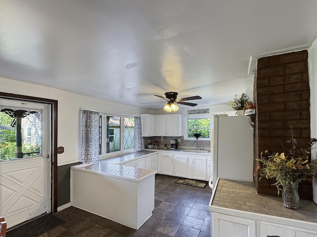 725 Opal St, Marseilles, IL 61341 - kitchen with freestanding refrigerator, a peninsula, healthy amount of natural light, and ceiling fan