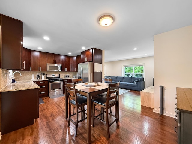 328 Thunderbird Trl, Carol Stream, IL 60188 - kitchen featuring stainless steel appliances, dark wood finished floors, decorative backsplash, dark brown cabinets, and recessed lighting