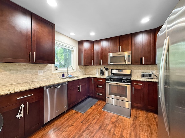 328 Thunderbird Trl, Carol Stream, IL 60188 - kitchen with stainless steel appliances, dark wood-type flooring, decorative backsplash, light stone counters, and recessed lighting