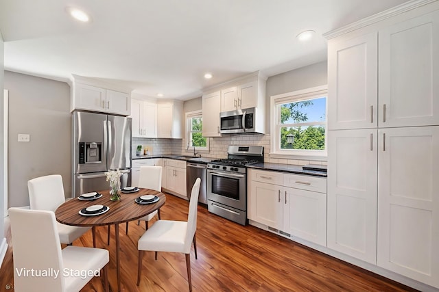 15 Ridge Rd, Lemont, IL 60439 - kitchen with appliances with stainless steel finishes, dark countertops, decorative backsplash, white cabinetry, and recessed lighting