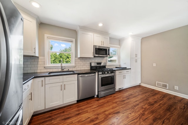 15 Ridge Rd, Lemont, IL 60439 - kitchen featuring stainless steel appliances, tasteful backsplash, dark wood finished floors, white cabinetry, and recessed lighting