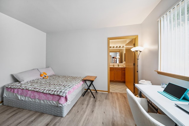 941 N Swift Rd Unit 201, Addison, IL 60101 - bedroom with light wood-type flooring, a desk, and ensuite bath