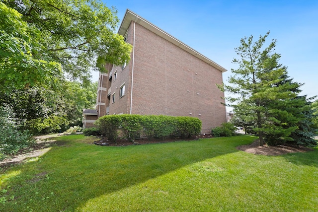941 N Swift Rd Unit 201, Addison, IL 60101 - view of home's exterior featuring a lawn and brick siding