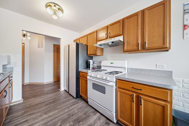 941 N Swift Rd Unit 201, Addison, IL 60101 - kitchen with white range with gas cooktop, under cabinet range hood, freestanding refrigerator, and light countertops