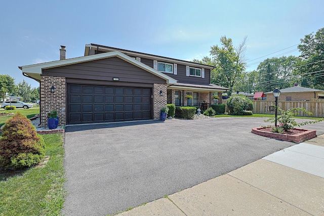 1008 S Beechwood Dr, Mount Prospect, IL 60056 - view of front of home featuring asphalt driveway, brick siding, a chimney, and an attached garage