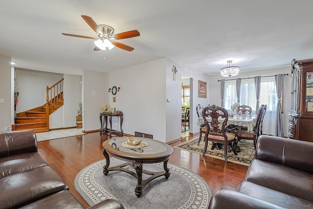 1008 S Beechwood Dr, Mount Prospect, IL 60056 - living area featuring wood finished floors, a ceiling fan, a chandelier, and stairs