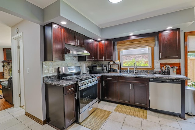 1008 S Beechwood Dr, Mount Prospect, IL 60056 - kitchen with appliances with stainless steel finishes, under cabinet range hood, tasteful backsplash, dark stone counters, and recessed lighting