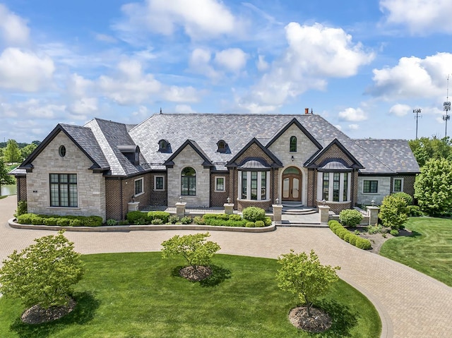 23 Enclave Ct, South Barrington, IL 60010 - french provincial home featuring stone siding, a high end roof, and a front yard