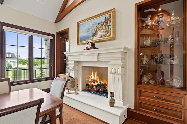 23 Enclave Ct, South Barrington, IL 60010 - dining room featuring vaulted ceiling, a lit fireplace, and wood finished floors