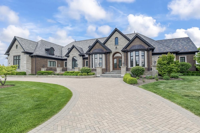 23 Enclave Ct, South Barrington, IL 60010 - french provincial home featuring brick siding, curved driveway, a high end roof, and a front yard