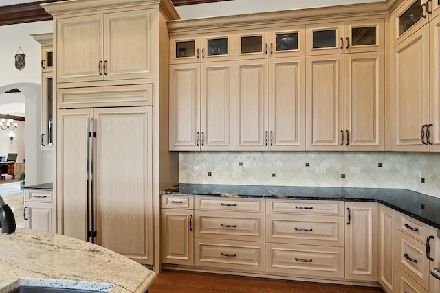 23 Enclave Ct, South Barrington, IL 60010 - kitchen with paneled built in fridge, dark stone countertops, tasteful backsplash, and glass insert cabinets