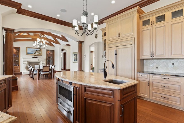 23 Enclave Ct, South Barrington, IL 60010 - kitchen featuring arched walkways, a chandelier, decorative columns, cream cabinetry, and recessed lighting