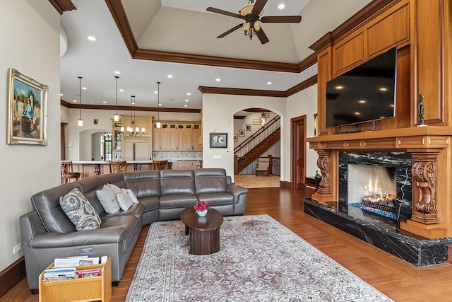 23 Enclave Ct, South Barrington, IL 60010 - living area featuring a high end fireplace, arched walkways, ceiling fan, crown molding, and stairs