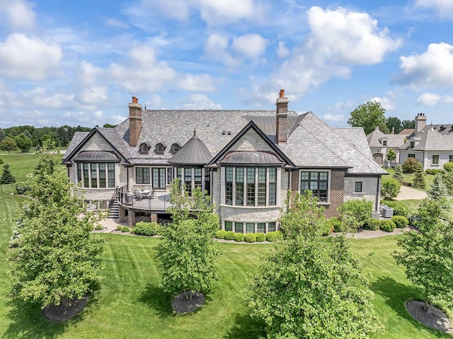 23 Enclave Ct, South Barrington, IL 60010 - rear view of property featuring a standing seam roof, a yard, a metal roof, a wooden deck, and a chimney