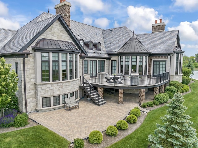 23 Enclave Ct, South Barrington, IL 60010 - back of property with a deck, a high end roof, a patio, and a chimney
