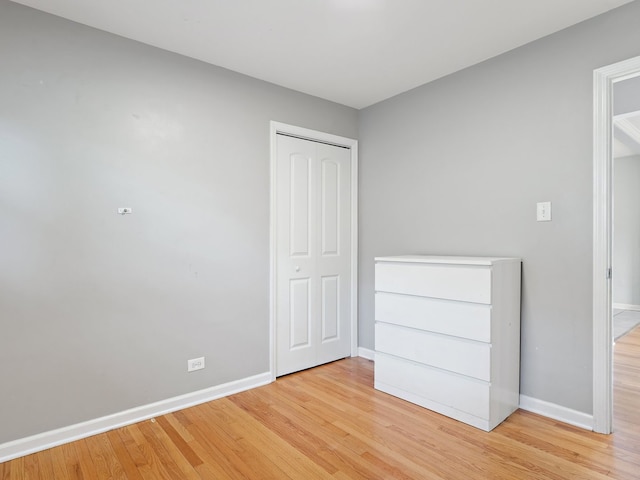 240 N Park Dr, Glenwood, IL 60425 - unfurnished bedroom featuring light wood-style floors and a closet
