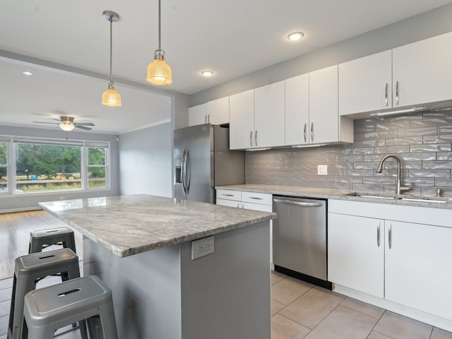 240 N Park Dr, Glenwood, IL 60425 - kitchen with stainless steel appliances, backsplash, a breakfast bar area, light stone countertops, and recessed lighting