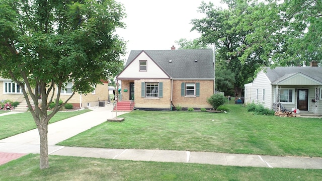 4225 Highland Ave, Downers Grove, IL 60515 - view of front facade with brick siding, a front yard, a shingled roof, and a chimney