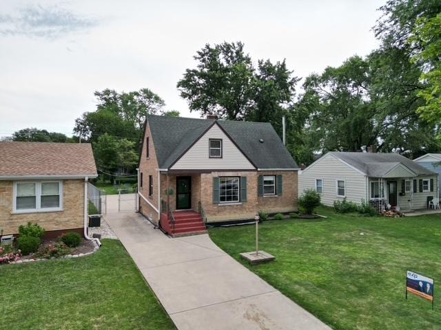 4225 Highland Ave, Downers Grove, IL 60515 - view of front of home featuring concrete driveway, brick siding, and a front yard