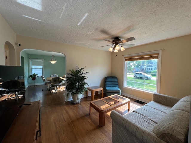 4225 Highland Ave, Downers Grove, IL 60515 - living area with arched walkways, wood finished floors, a textured ceiling, ceiling fan, and plenty of natural light