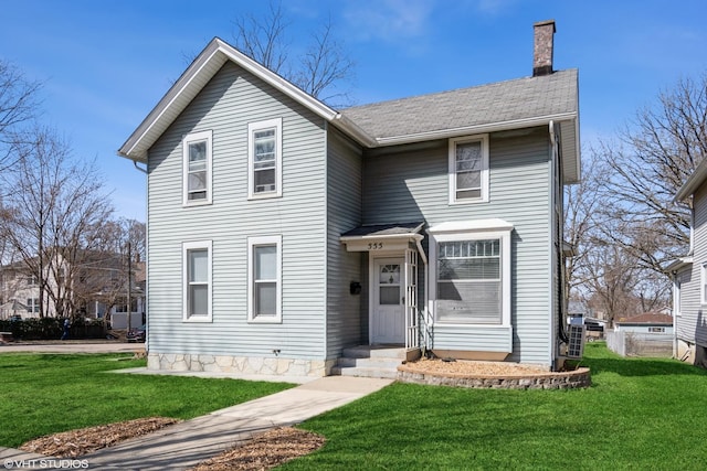 555 S Lasalle St, Aurora, IL 60505 - view of front facade featuring a chimney and a front yard