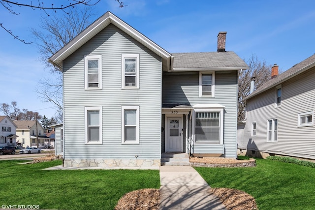 555 S Lasalle St, Aurora, IL 60505 - view of front of home with a front yard and a chimney