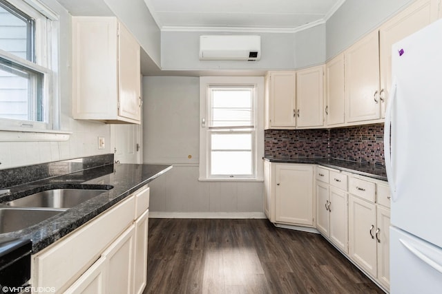 555 S Lasalle St, Aurora, IL 60505 - kitchen featuring freestanding refrigerator, dark wood-style floors, tasteful backsplash, crown molding, and white cabinetry