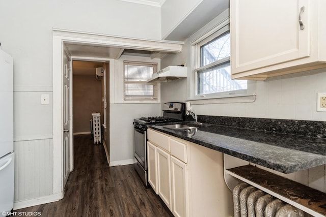 555 S Lasalle St, Aurora, IL 60505 - kitchen with stainless steel gas range oven, ventilation hood, dark wood-style floors, radiator heating unit, and dark stone countertops