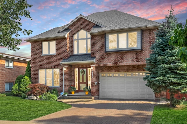 8453 W Bruce Dr, Niles, IL 60714 - view of front of house featuring a garage, decorative driveway, a shingled roof, brick siding, and a front lawn