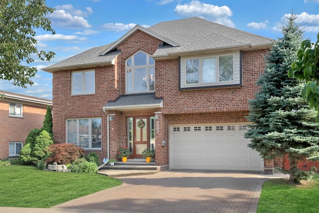 8453 W Bruce Dr, Niles, IL 60714 - traditional-style house featuring decorative driveway, an attached garage, a front yard, brick siding, and a shingled roof