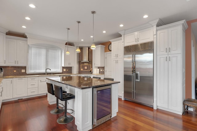 8453 W Bruce Dr, Niles, IL 60714 - kitchen featuring stainless steel built in fridge, wine cooler, wall chimney range hood, white cabinets, and recessed lighting